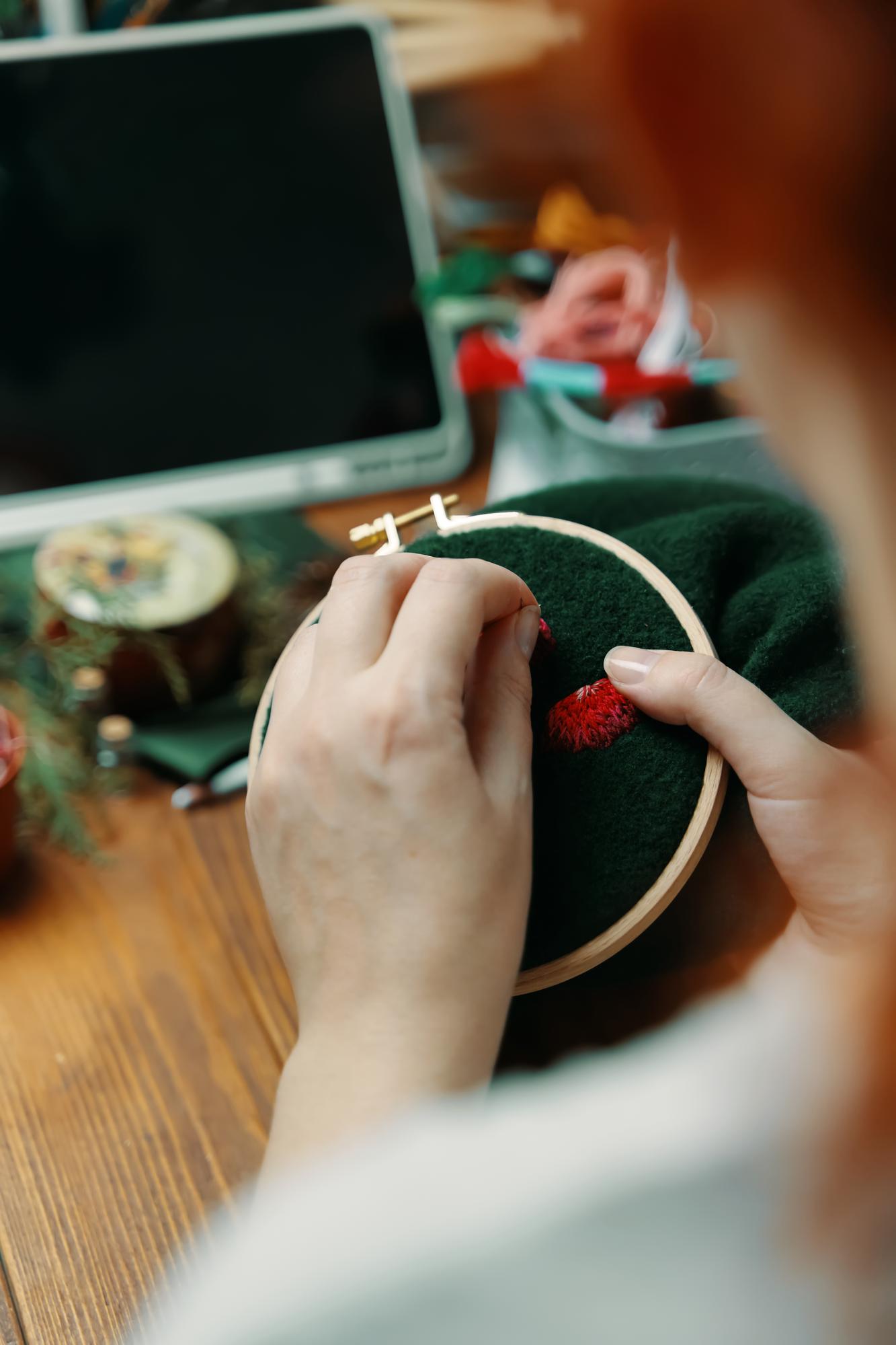 Instructor demonstrating embroidery technique